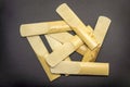 Bamboo saxophone reeds lying in a mess on a black background Royalty Free Stock Photo