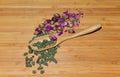 Bamboo spoon with ginseng tea and dried rosebud