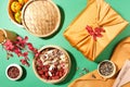 Bamboo steamer holds tangerines, jam, jujubes and gummy candy. Melon seeds and sunflower seeds are stored in small bowls, a gift