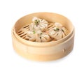 Bamboo steamer with tasty baozi dumplings on white Royalty Free Stock Photo