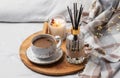 Bamboo sticks in bottle with scented candles and cup of coffee Royalty Free Stock Photo