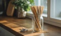 Bamboo straws in glass jar with lavender and wheat on wood surface Royalty Free Stock Photo