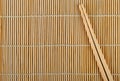 Bamboo sushi mat and chopsticks on top Royalty Free Stock Photo