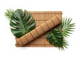 A bamboo sushi mat is placed on a white background, adorned Royalty Free Stock Photo