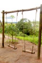 Bamboo swing of the ethnic group and the green hill Royalty Free Stock Photo