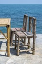 Bamboo table and wooden chairs in empty cafe next to sea water in tropical beach . Island Koh Phangan, Thailand Royalty Free Stock Photo