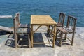 Bamboo table and wooden chairs in empty cafe next to sea water in tropical beach . Island Koh Phangan, Thailand Royalty Free Stock Photo