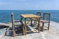 Bamboo table and wooden chairs in empty cafe next to sea water in tropical beach . Island Koh Phangan, Thailand Royalty Free Stock Photo