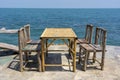 Bamboo table and wooden chairs in empty cafe next to sea water in tropical beach . Island Koh Phangan, Thailand Royalty Free Stock Photo