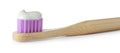 Bamboo toothbrush for children with paste isolated on white, closeup. Dental care
