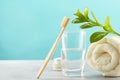 A bamboo toothbrush, a glass of water, a white cotton towel and toothbrush powder in a jar. Biodegradable personal care Royalty Free Stock Photo