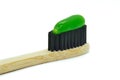 Bamboo toothbrush with green mint toothpaste isolated on white background. Royalty Free Stock Photo