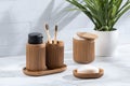 bamboo toothbrush holder and other bathroom items on a counter