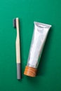 Bamboo toothbrush and organic toothpaste on green background Royalty Free Stock Photo