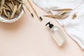 Bamboo toothbrush on a table with copy space on a pink background. Styled composition of flat lay with dried eucalyptus