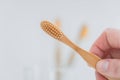 bamboo toothbrush.Teeth cleaning.Toothbrush in hand under tap water in bathroom. Hand takes a toothbrush from a Royalty Free Stock Photo