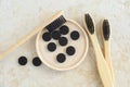 Bamboo toothbrushes with black bristles and activated charcoal tablets pills. Eco friendly toiletries set. Natural dental health