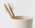 Bamboo toothbrushes in eco cup on white background. Copy space, close up. Zero waste Royalty Free Stock Photo