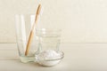 Bamboo toothbrushes, glass of water, dentifrice tooth powder on white background. Biodegradable natural bamboo toothbrush. Eco