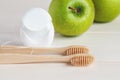 Bamboo toothbrushes, green apples and dental floss