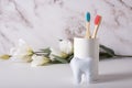 Bamboo toothbrushes with pink and blue bristles in a white beaker Royalty Free Stock Photo