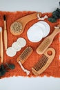 Bamboo toothbrushes, wooden body brushes and soap with natural ingredients on an orange towel on a white table Royalty Free Stock Photo