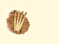 Bamboo toothbrushes on a wooden saw on a beige background. Ecostyle. Zero waste
