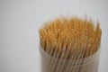 Bamboo toothpicks in a round plastic box on the table closeup Royalty Free Stock Photo