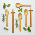 Bamboo utensils, including a fork, chopsticks, and spoons, are neatly arranged on a Royalty Free Stock Photo
