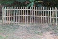 A bamboo wall fence set on an outdoor lawn.