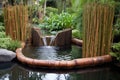 bamboo water feature with flowing water Royalty Free Stock Photo