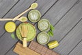Bamboo whisk in bowl with matcha powder. Matcha green tea, macaroni cakes and wooden spoons on table Royalty Free Stock Photo