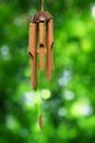 Bamboo wind chime isolated on a green background Royalty Free Stock Photo