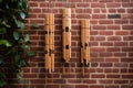 bamboo wind chimes hanging against a brick wall background Royalty Free Stock Photo