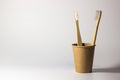 Bamboo wooden toothbrushes on white background with stand and craft glass. care for ecology and the environment. hygiene.