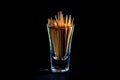 bamboo wooden toothpicks in glass jar, wine glass. in bucket. toothpicks on black background. front view toothpicks, dropped from Royalty Free Stock Photo