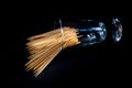 bamboo wooden toothpicks in glass jar, wine glass. in bucket. toothpicks on black background. front view toothpicks, dropped from Royalty Free Stock Photo