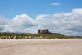 Bamburgh Castle Northumberland north east England UK with white sandy beach Royalty Free Stock Photo