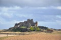 Bamburgh Castle In Northumberland over the dunes Royalty Free Stock Photo