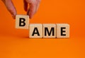 BAME symbol. Abbreviation BAME, black, asian and minority ethnic on wooden cubes. Beautiful orange background. Copy space. Royalty Free Stock Photo