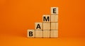 BAME symbol. Abbreviation BAME, black, asian and minority ethnic on wooden cubes. Beautiful orange background. Copy space. Royalty Free Stock Photo