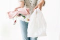 Ban single use plastic. Zero Waste shopping concept. Woman holding in one hand groceries in reusable eco bag and in other Royalty Free Stock Photo