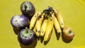 Banana, Apple And Brinjal. Background Yellow. Royalty Free Stock Photo