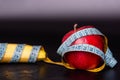 banana and an apple wrapped in a tape measure Royalty Free Stock Photo