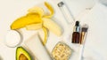 Banana and avocado for a handmade face mask and ingredients on a white table. Skin care.