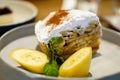 Banana Banoffee pie with bananas slice and peppermint leaves on gray ceramic plate