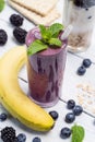 Banana, blueberry, blackberry, oatmeal and yogurt smoothies in a glass