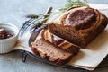 Banana bread with chocolate and chocolate spread on grey background with lavender flowers