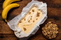 Banana bread. Cooking. Vegetarian food. Raw muffin with bananas and nuts on a wooden background Royalty Free Stock Photo