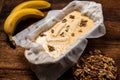 Banana bread. Cooking. Vegetarian food. Raw muffin with bananas and nuts on a wooden background Royalty Free Stock Photo